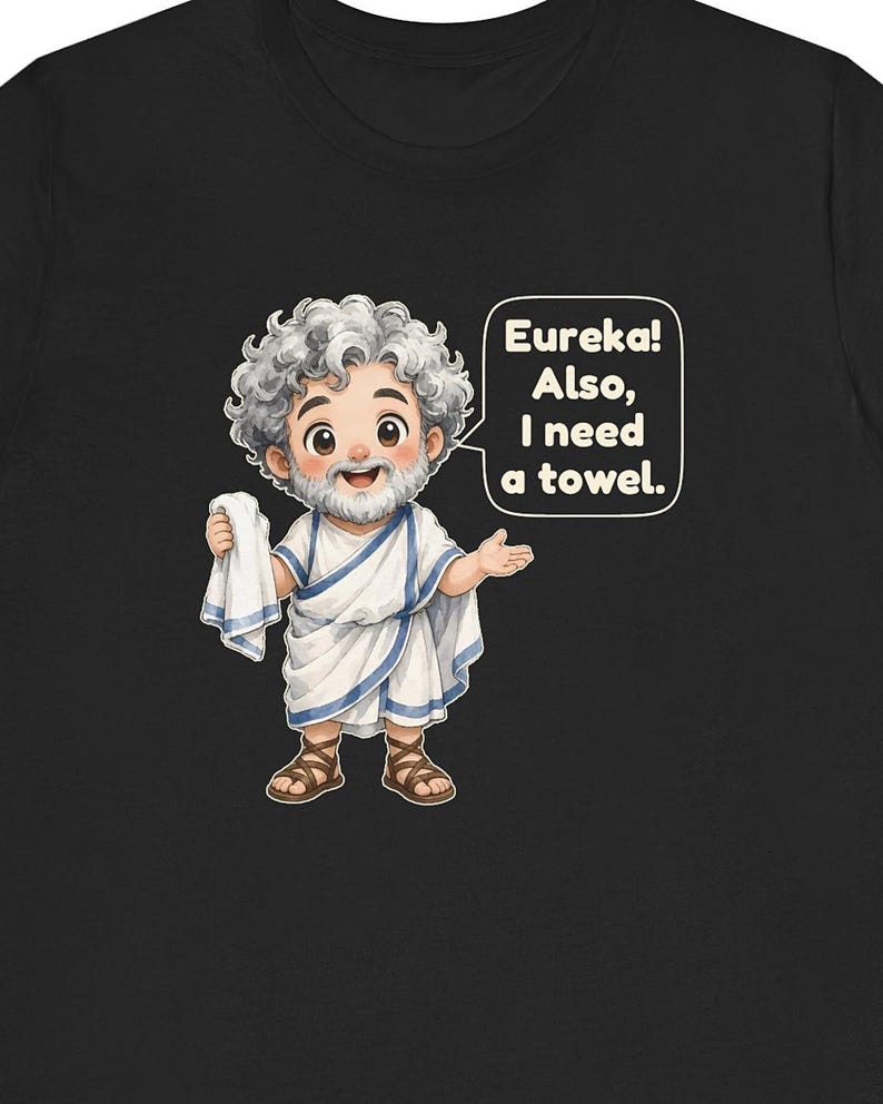 May include: A black t-shirt featuring a cartoon illustration of a bearded man with curly gray hair wearing a white toga with blue trim and brown sandals. The man holds a white towel and a speech bubble reads: Eureka! Also, I need a towel.