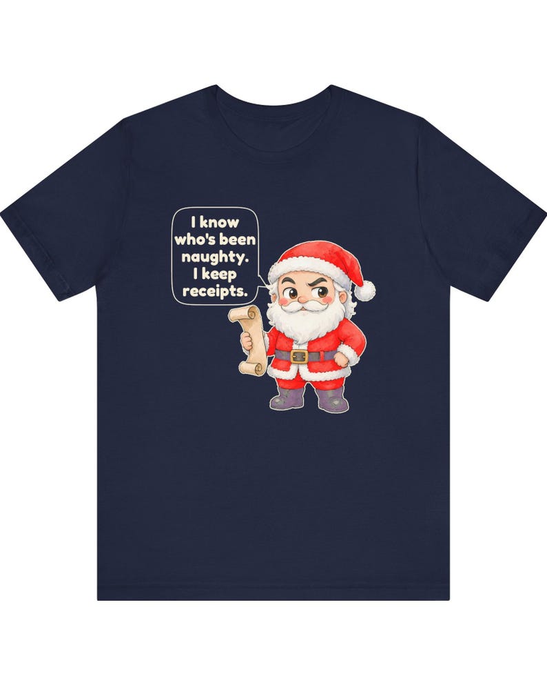 May include: A navy blue t-shirt featuring a cartoon illustration of Santa Claus holding a scroll. A speech bubble next to Santa contains the text: I know who's been naughty. I keep receipts. Santa wears a red suit with white trim and a black belt.