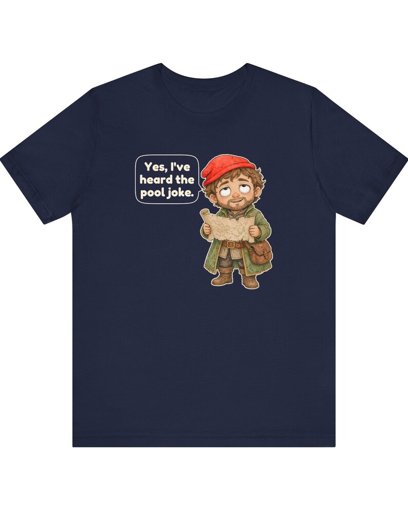 May include: A navy blue short-sleeved t-shirt featuring a cartoon illustration of a bearded character in a red cap and green coat holding a map. A speech bubble above the character contains the text: Yes, I've heard the pool joke.
