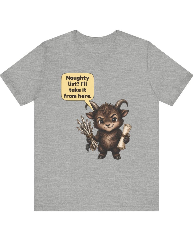 Puede incluir: Una camiseta gris jaspeado con el gr&aacute;fico de una peque&ntilde;a criatura marr&oacute;n con cuernos que sostiene un manojo de palos y un pergamino. Un globo de texto amarillo sobre la criatura contiene el texto: Naughty list? I'll take it from here.