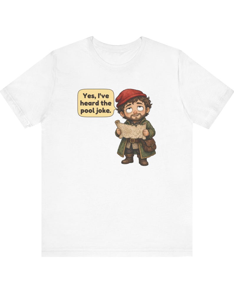 May include: A white t-shirt featuring a cartoon illustration of a bearded character wearing a red cap and green coat, holding a map. A speech bubble next to the character contains the text: Yes, I've heard the pool joke.