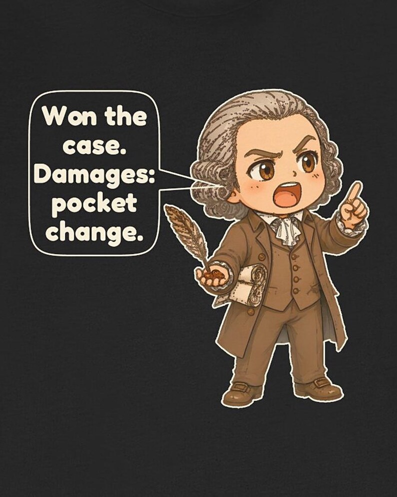 May include: A black t-shirt featuring a cartoon illustration of a person in 18th-century brown attire holding a quill and a scroll. A speech bubble contains the text: Won the case. Damages: pocket change. The character has brown hair.