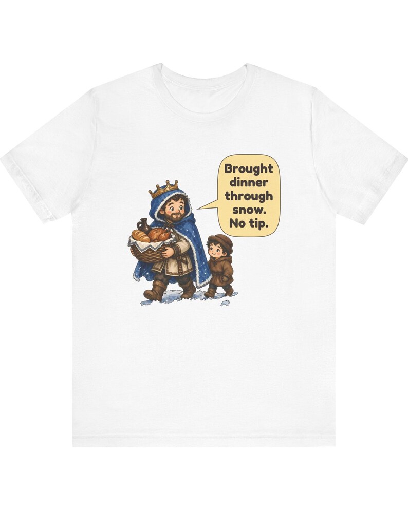 May include: A white short-sleeve t-shirt featuring a graphic of a king in a blue cloak carrying a basket of bread and a child walking through snow. A speech bubble contains the text: Brought dinner through snow. No tip.