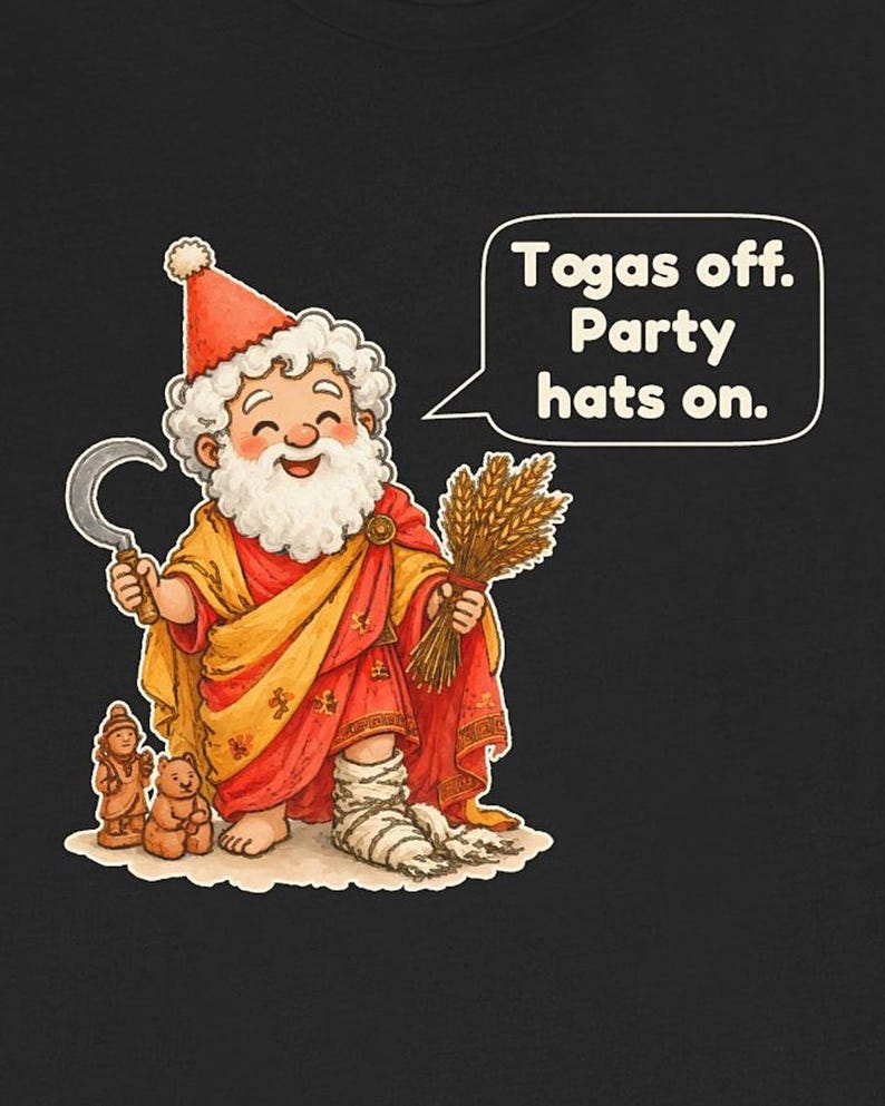 May include: A black t-shirt featuring a cartoon illustration of a bearded figure wearing a red party hat, a yellow and red robe, and a white leg wrap. The figure holds a silver sickle and wheat, with text that reads: Togas off. Party hats on.