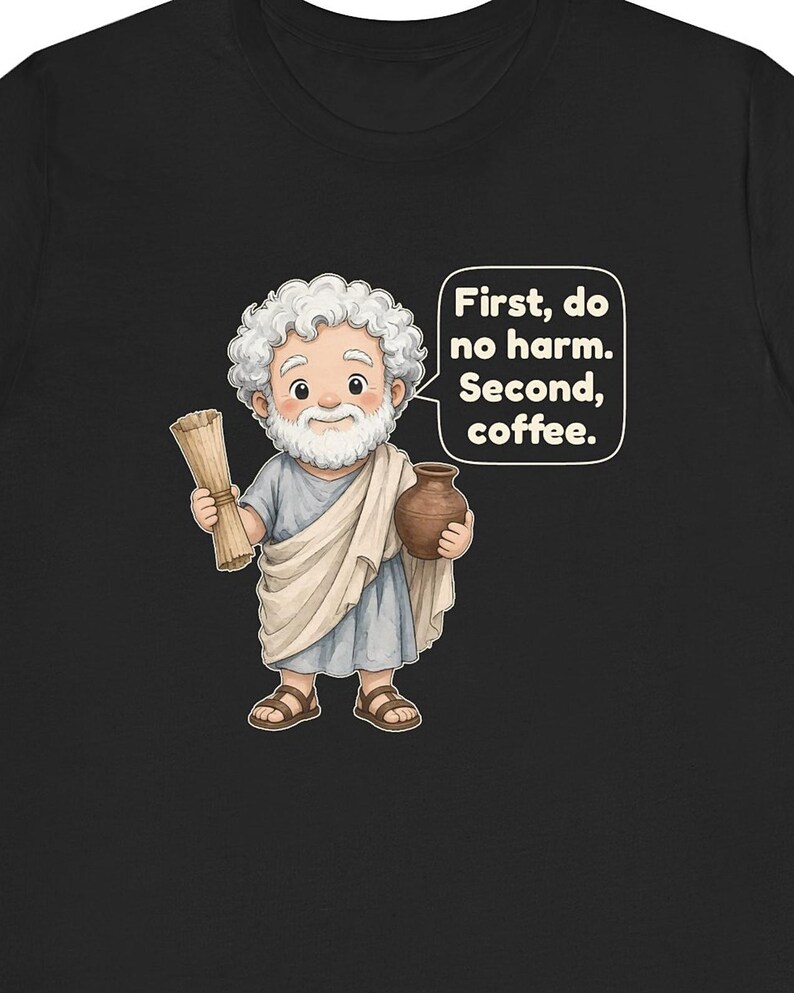 May include: A black t-shirt featuring a cartoon illustration of a white-bearded figure in a light blue tunic and beige toga, holding a scroll and a brown pot. A speech bubble contains the text: First, do no harm. Second, coffee.