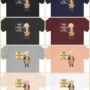 May include: A collection of eight short-sleeve t-shirts in various colors, each featuring a cartoon illustration of George Washington and a speech bubble with the text, I didn't cross a freezing river for this.