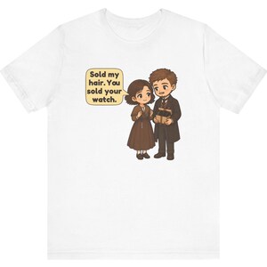 May include: A white t-shirt featuring a cartoon illustration of two people in brown clothing. One person holds a small box, and a speech bubble contains the text: Sold my hair. You sold your watch.