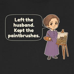 May include: A black t-shirt featuring a cartoon illustration of a person in a purple dress holding a paint palette and brush next to an easel. A speech bubble contains the text: Left the husband. Kept the paintbrushes.