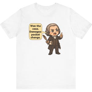 May include: A white t-shirt featuring a cartoon illustration of a historical figure in a brown suit holding a quill and scroll. A speech bubble contains the text: Won the case. Damages: pocket change.