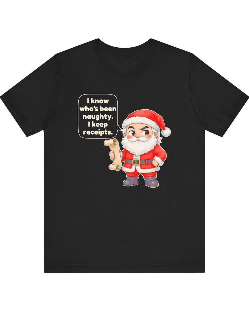 May include: A black t-shirt featuring a cartoon illustration of Santa Claus holding a scroll. Santa wears a red suit with white trim and a black belt. A speech bubble above him contains the text: I know who's been naughty. I keep receipts.