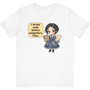 May include: A white t-shirt featuring a cartoon illustration of a person in a dark blue Victorian-style dress holding punch cards and papers. A yellow speech bubble contains the text: I wrote code before computers. Flex.