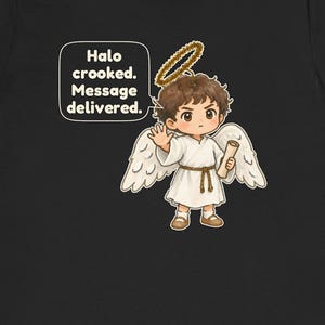 May include: A black t-shirt featuring a graphic of a brown-haired angel with a golden halo, white wings, and a white robe tied with a rope belt. The angel holds a scroll and has a speech bubble that reads: Halo crooked. Message delivered.