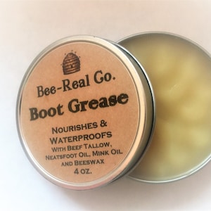 May include: A small tin container of Bee-Real Co. Boot Grease, a natural leather conditioner. The label is brown with black text and a beehive logo. The tin contains a yellow-colored grease. The label reads "Nourishes & Waterproofs with Beef Tallow, Neatfoot Oil, Mink Oil and Beeswax 4 oz."