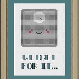 May include: A gray scale digital scale with a smiling face and the text "WEIGHT FOR IT..." printed below.