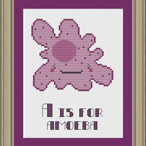Peut inclure: Broderie au point de croix encadrée dans un cadre doré, représentant une amibe souriante de dessin animé dans des tons violets. Le texte "A IS FOR AMOEBA" est brodé en dessous. L'œuvre est encadrée d'un passe-partout violet.
