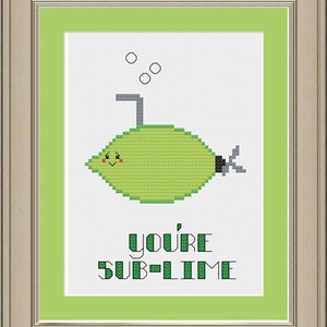 Op de afbeelding: Een groene limoen-vormige onderzeeër met een glimlachend gezicht en een rietje dat uit de bovenkant steekt. De tekst "you're sub-lime" staat onder de onderzeeër.