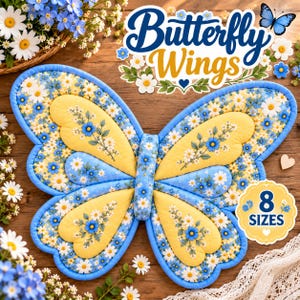 May include: A quilted fabric butterfly-shaped mat featuring a yellow and blue floral pattern with white daisies and blue forget-me-nots. The design includes a central body section and four wings with blue piping edges. Text on the image reads Butterfly Wings and 8 SIZES.