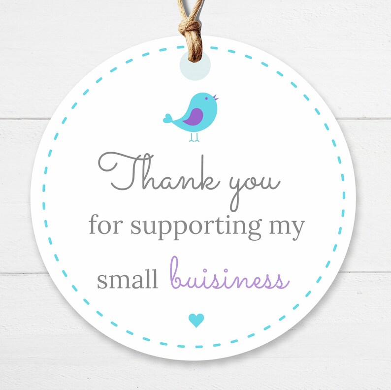 May include: A white, circular tag with a blue dotted border and a brown string. The tag features a blue bird illustration and the text "Thank you for supporting my small business" in grey and purple.