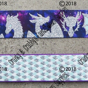 May include: Two different ribbon designs featuring a silver glitter dragon silhouette on a purple and blue galaxy print and a white and blue geometric pattern. The ribbon is 1.5 inches wide.