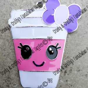 May include: A kawaii-style coffee cup charm with a smiling face, black eyes, and a purple bow. The cup is white with a pink band and silver trim. The charm has a loop for attaching to a keychain or necklace.