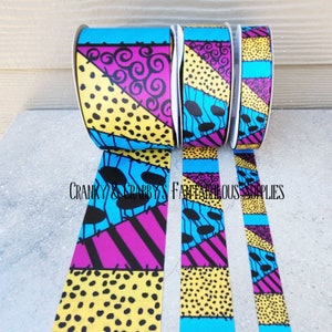 May include: Three rolls of colourful patterned ribbon with a patchwork design featuring blue, yellow, pink, and black. The ribbon is inspired by the character Jack Skellington from the movie The Nightmare Before Christmas.