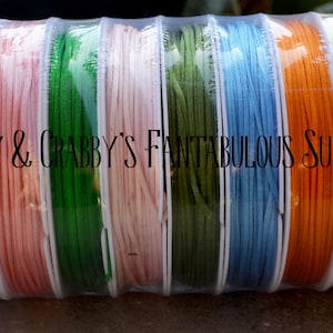 May include: A close-up of ten spools of waxed cotton cord in various colors, including gray, lavender, pink, green, olive green, light blue, orange, yellow, and blue. The spools are packaged in clear plastic and labeled "Cranky & Crabby's Fantabulous Supplies".