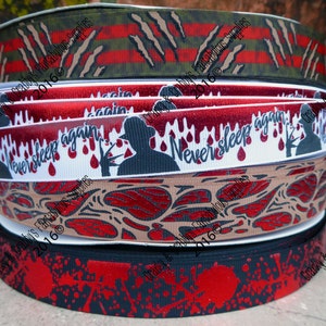 May include: A stack of four different patterned ribbons featuring a horror movie theme. The ribbons are black, white, red, and green with various designs including blood drops, a silhouette of a man holding a knife, and a pattern of leaves. The text "Never sleep again" is printed on one of the ribbons.