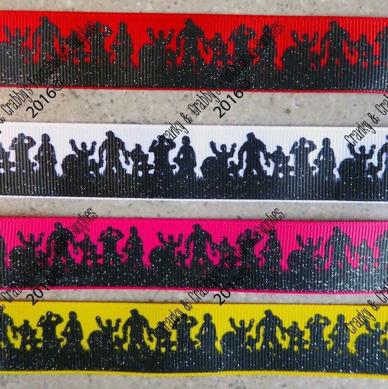 May include: Four different colored ribbon trims with a black silhouette of a band playing music. The ribbon trims are red, white, pink, and yellow. The text "Cranky & Crabby's 2016" is on the red and white ribbon trims.