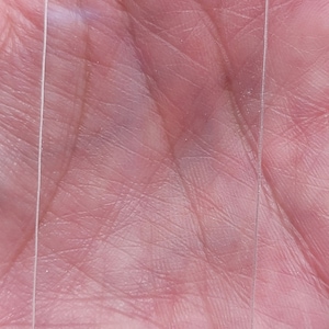 May include: A clear plastic tag with a hole at the top. The tag has the text "Cranky & Crabby's Fantabulous Supplies" printed on the bottom.