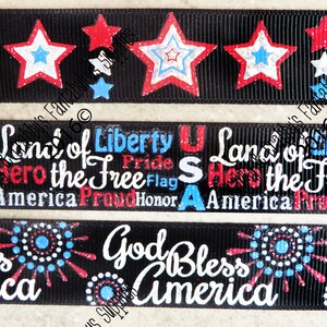 May include: Black ribbon with patriotic designs. The top ribbon features red, white, and blue stars. The middle ribbon has the text "Land of Liberty, Hero the Free, America, Proud, Honor". The bottom ribbon says "God Bless America".