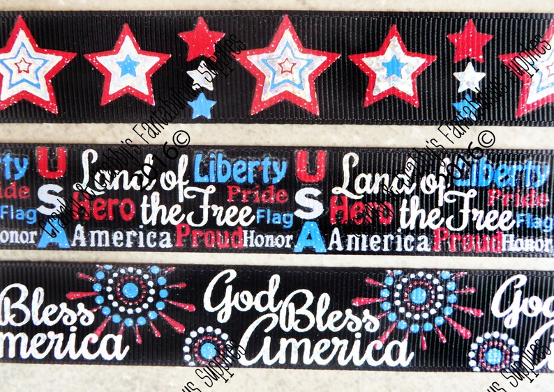 May include: Black ribbon with patriotic designs. The top ribbon features red, white, and blue stars. The middle ribbon has the text "Land of Liberty, Hero the Free, America, Proud, Honor". The bottom ribbon says "God Bless America".