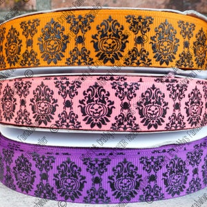 May include: Three rolls of Halloween ribbon with a black damask pattern and orange, pink, and purple backgrounds. Each roll features a black jack-o'-lantern design.