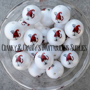 May include: A bowl of white round beads with a red and white gnome design. The gnome is wearing a red hat and has a tail. The gnome is holding a pitchfork. The text "CRANKY & CRABBY'S FANTABULOUS SUPPLIES" is printed on the bottom of the bowl.
