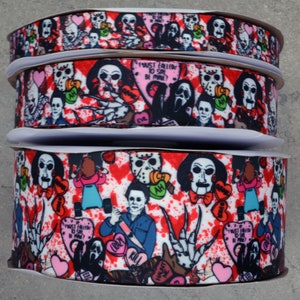 May include: A red, white, and black ribbon with a horror movie theme. The ribbon features images of iconic horror movie characters, including Freddy Krueger, Jason Voorhees, and Michael Myers. The ribbon also includes hearts with phrases like "I must follow to see if you'll be mine?" and "Crazy in love".