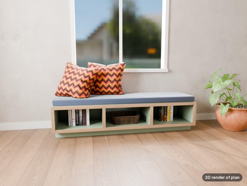 May include: A low rectangular storage bench with a light wood frame and a light blue seat cushion. Two square pillows with a red, orange, and black chevron pattern sit on the cushion. The base features three open cubbies containing books and a basket.