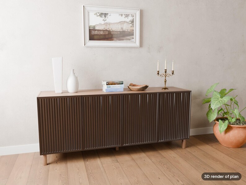 May include: A long, dark brown sideboard with a vertical ribbed texture on the four cabinet doors, supported by light-coloured wooden legs. The top surface holds two white vases, a stack of books, a wooden bowl, and a gold-toned candelabra.