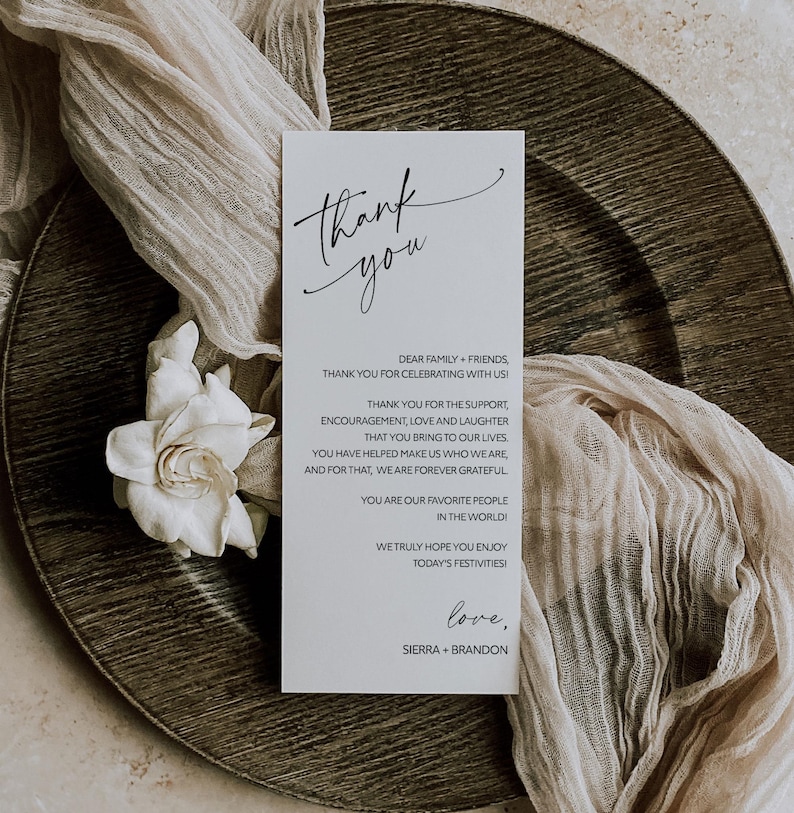May include: A white thank you card with black calligraphy that reads "Thank you". The card has a message thanking family and friends for celebrating with the couple, Sierra and Brandon.