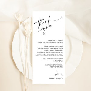 May include: A simple, elegant thank you card with a handwritten script font. The card reads "Thank you" in a large script font at the top and includes a message of gratitude to family and friends for their support and encouragement. The card is signed "love, Sierra + Brandon".