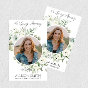 May include: Two white memorial cards with green floral borders and a photo of a woman. The text on the cards reads "In Loving Memory" and includes the name and dates of the deceased.