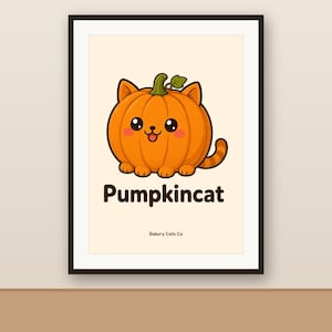 Op de afbeelding: Een ingelijste kunstdruk met een oranje pompoen in de vorm van een kat met oren, een staart en een lachend gezicht. Onder de illustratie staat de tekst Pumpkincat in vetgedrukte letters, met de kleinere tekst Dakery Cats Co eronder.