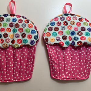 Cupcake shaped potholders.  Pink w/ white dots and donuts frosting.  Set of 2