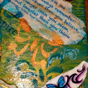 May include: A wooden box with a blue, green, and gold background. The box has a quote from Winnie the Pooh about being brave, strong, and smart. The box also has a butterfly and a metal charm with the words "Live life to the fullest".