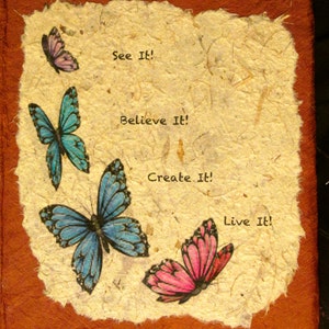 May include: A brown paper journal cover with a beige paper insert featuring four butterflies and the text "See It! Believe It! Create It! Live It!"