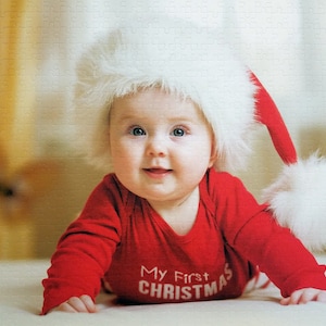 Custom photo puzzle with 500 pieces of picture puzzle with baby wearing First Christmas top and hat.  Personalized puzzle of baby with 500 pieces on the picture puzzle.