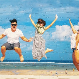 Puzzle from your picture of a family on a beach jumping on the sand.  The personalized puzzle is cheap but made well and features 60 pieces.
