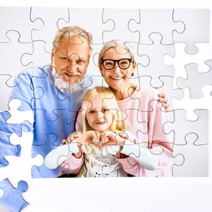 Custom Puzzle Gift Fast. Personalized Kids photo puzzle. Personalized Jigsaw Puzzle for the puzzle lover.  This 30 piece kids puzzle shows grandparents with granddaughter cut into a personalized puzzle that is being assembled.
