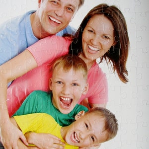 personalized picture puzzle from a photo of a family of four smiling.  This personalized puzzle has been cut into thick puzzle pieces and is sturdy.