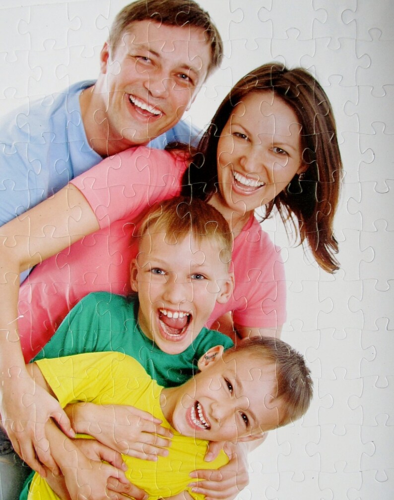 personalized picture puzzle from a photo of a family of four smiling.  This personalized puzzle has been cut into thick puzzle pieces and is sturdy.