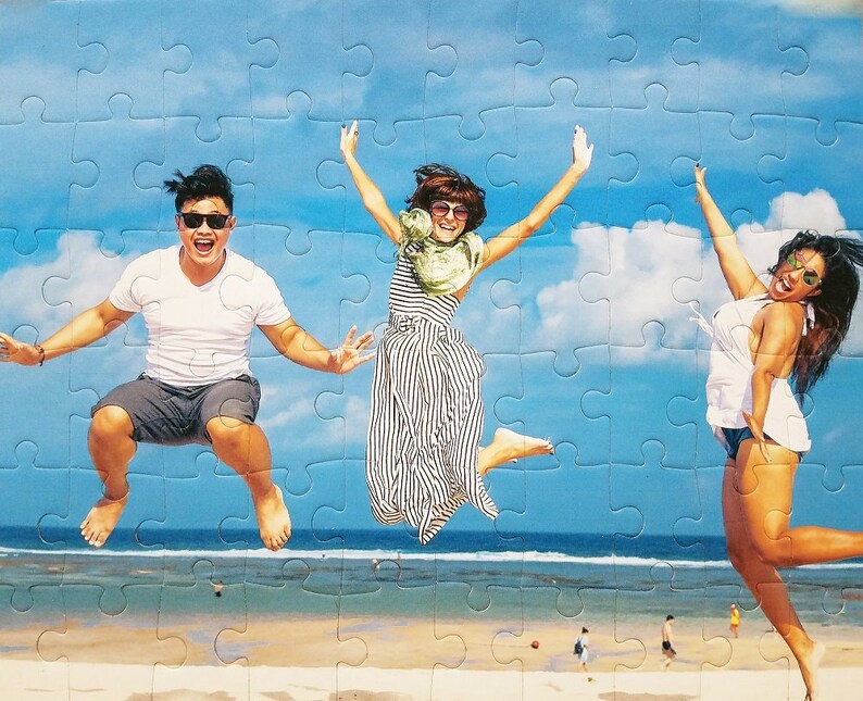 Custom Puzzle Gift Fast.  This 60 piece puzzle gift shows three people jumping at the beach.  This Personalized Jigsaw Puzzle features extra large puzzle pieces and is a keepsake for the puzzle lover