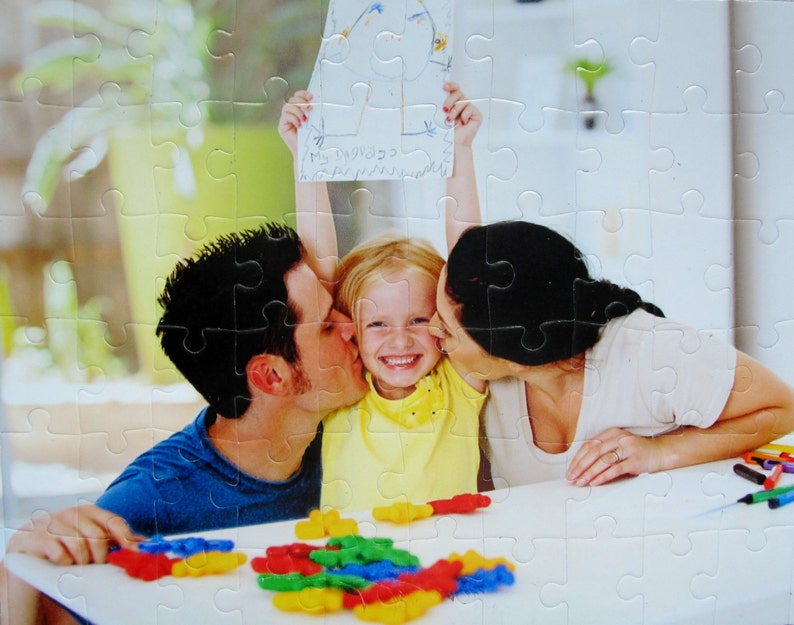birthday gift of a custom puzzle showing a family doing a puzzle together.  This picture to puzzle has been cut and assembled.